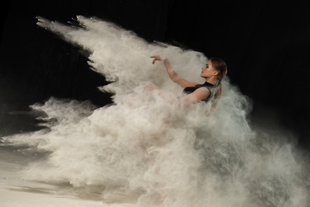Girl dancing with flour on black background one personの写真素材