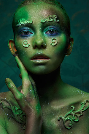 girl with creative green make-up in the image of a forest spirit