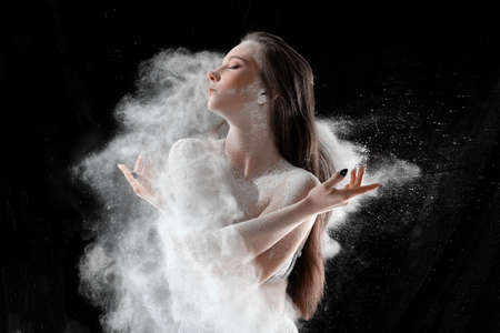 Girl dansing with flour on black background one personの写真素材