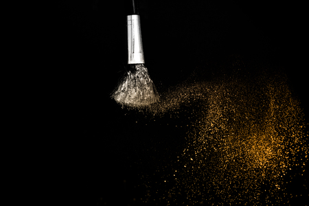 golden powder splash and brush for makeup artistの写真素材