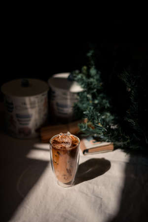 Close-up glass of iced coffee with milk on the tableの写真素材