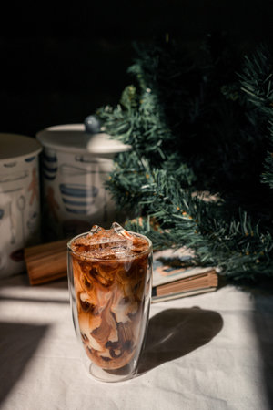 Close-up glass of iced coffee with milk on the table