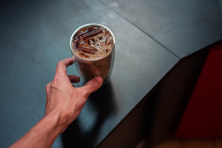 Close-up glass of iced coffee with milk on the table