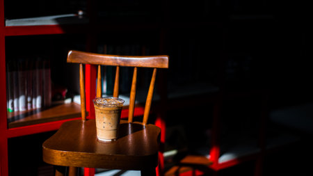 Close-up glass of iced coffee with milk on the tableの写真素材