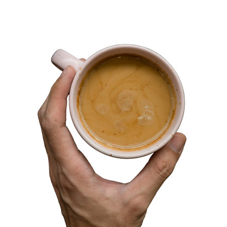 Cup of coffee in hand isolated on white background, top viewの写真素材