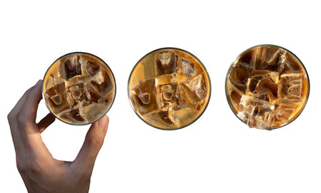 Iced coffee in a glass with ice cubes on a white background