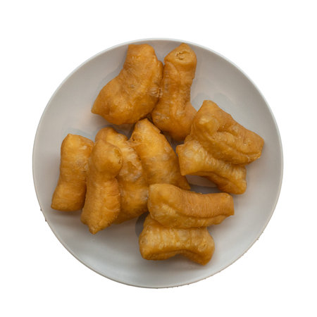 Deep-fried dough stick on a plate isolated on white background.