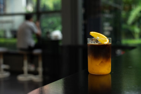 Iced coffee with lemon on table in coffee shop, stock photo