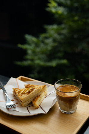 Coffee and toast on wooden table in coffee shop, stock photoの写真素材