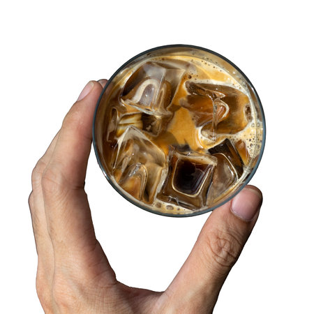 Iced coffee with ice cubes in hand isolated on white background.