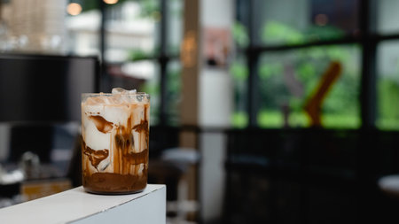 iced coffee on table in coffee shop blur background with bokeh