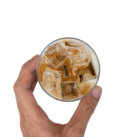 Iced coffee with ice cubes in hand isolated on white background.の写真素材