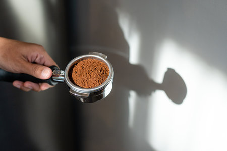 Coffee grinder with ground coffee in hand, stock photoの写真素材