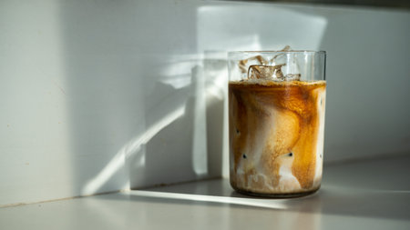 Iced coffee in a glass on a white table. Selective focus.の写真素材