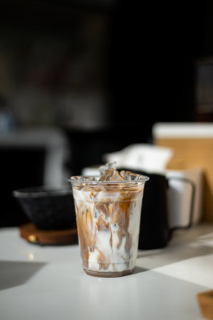 Iced coffee in plastic cup on table in coffee shop, stock photoの写真素材