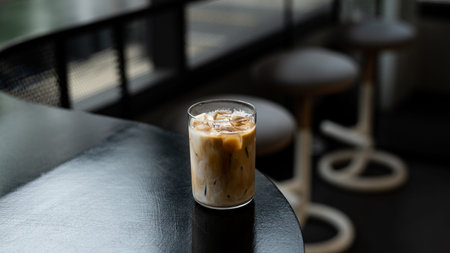 Iced coffee in a glass on table in coffee shop, stock photo