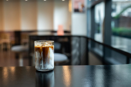 Iced coffee in a glass on the table in coffee shop.