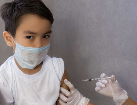 Child vaccination, virus vaccination, coronavirus vaccine, syringe shot to prevent influenza. Health conceptの写真素材