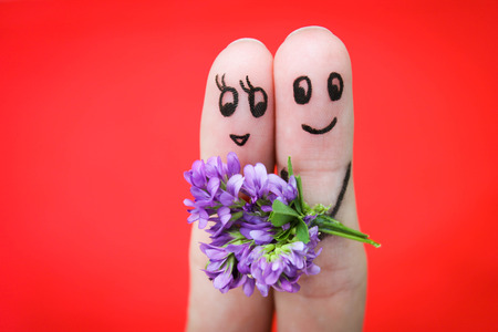 Happy couple  Man is giving flowers to a woman  の写真素材