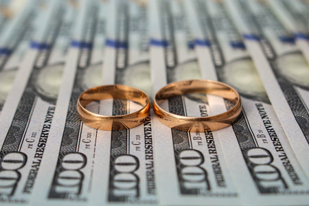 Wedding rings on the background of moneyの写真素材