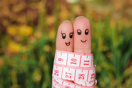 Finger art of a Happy couple with meter. The concept of losing weight together.の写真素材