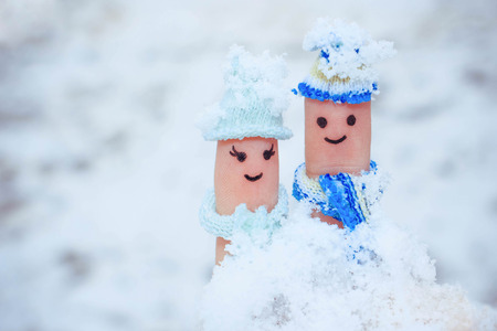 Finger art of a Happy couple on the background of snow. Toned image.の写真素材