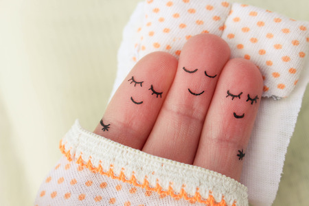 Finger art. Happy man sleeps with two women.の写真素材