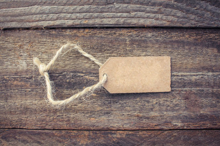 Label on old wood background. Toned image