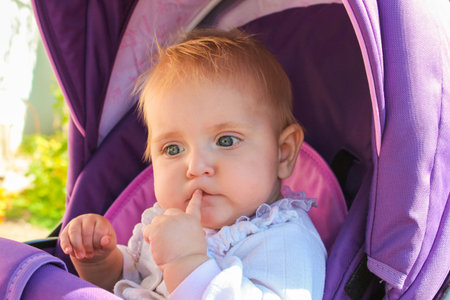 small child sits in the stroller. The girl thought.
