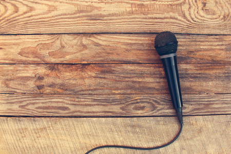 Microphone on wooden background. Toned image.の写真素材