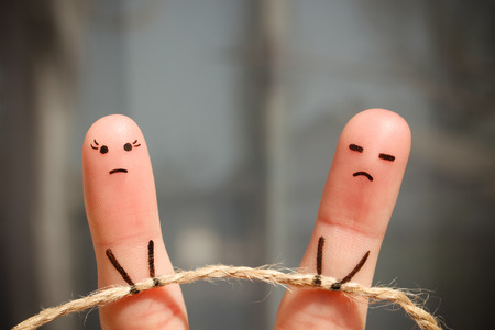 Finger art of couple. Woman and man pull rope. Couple quarreled, can not solve the problem, a misunderstanding.の写真素材
