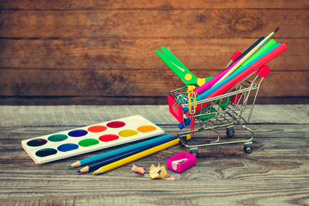 Shopping cart with stationery objects. Office and school supplies.の写真素材