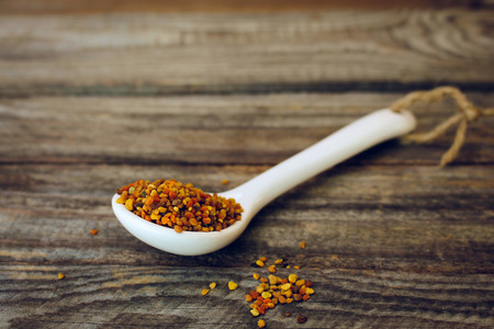 Bee pollen on old wooden background. Toned image.の写真素材