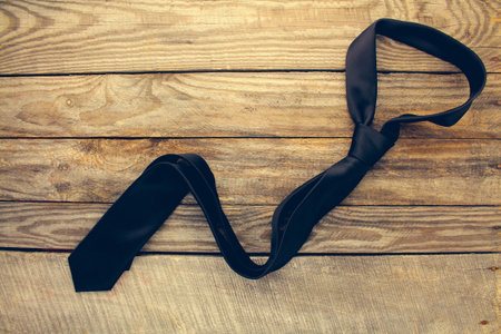 Tie on old wood background. Toned image. Top view.の写真素材