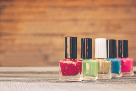 Nail polish on the old wooden background. Toned image.の写真素材
