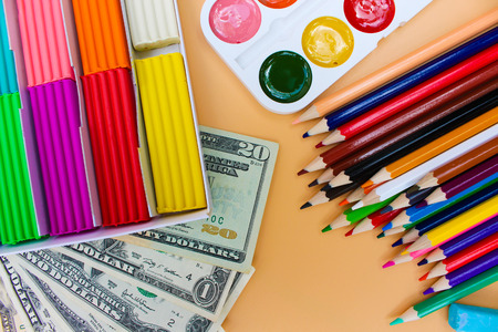 School supplies and dollars. Concept is to buy stationery objectsの写真素材