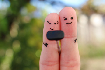 Fingers art of Happy couple. Man and women take pictures of themselves on the phone, self.の写真素材