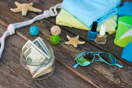 Dollars in glass jar. Concept of collecting money for journey.の写真素材