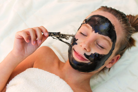 Beautiful girl with facial black mask.