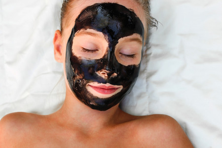 Beautiful girl with facial black mask.の写真素材