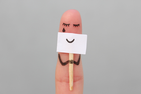 Fingers art of lonely woman is crying. Concept of people hiding emotions.の写真素材