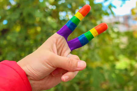 Hand gesture victory with gay pride rainbow.の写真素材