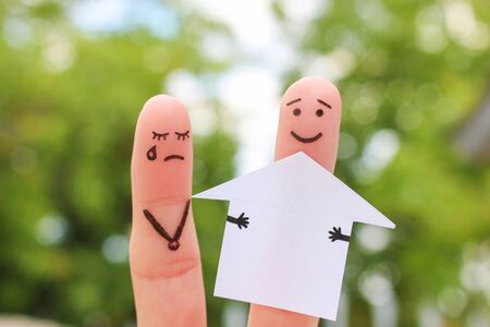 Finger art of family during quarrel. Concept of man and woman divide house after divorce.の写真素材