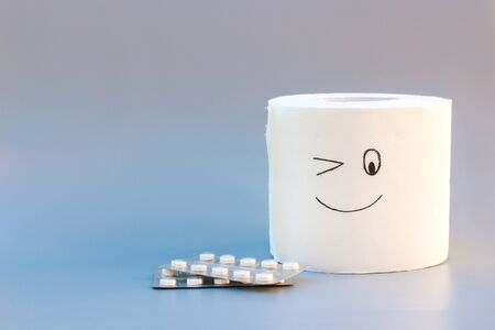 Toilet paper and pills. Concept of hemorrhoid treatment.の写真素材