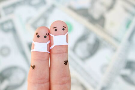 Fingers art of couple with face mask on background of money.の写真素材