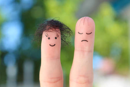 Fingers art of couple. This man is upset because he is bald.の写真素材