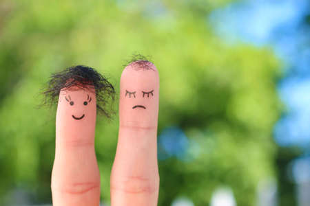 Fingers art of couple. This man is upset because he is bald.の写真素材