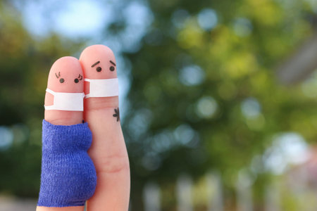 Fingers art of couple in medical mask from COVID-2019. Woman is pregnant.