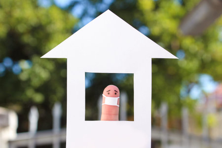 Fingers art of lonely man with face mask at home.