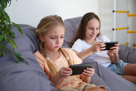Children play with a mobile phone at home